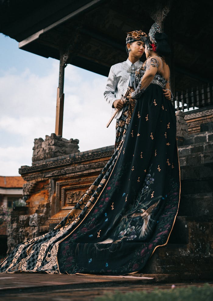 A couple in traditional wear at a temple, showcasing cultural heritage and togetherness.